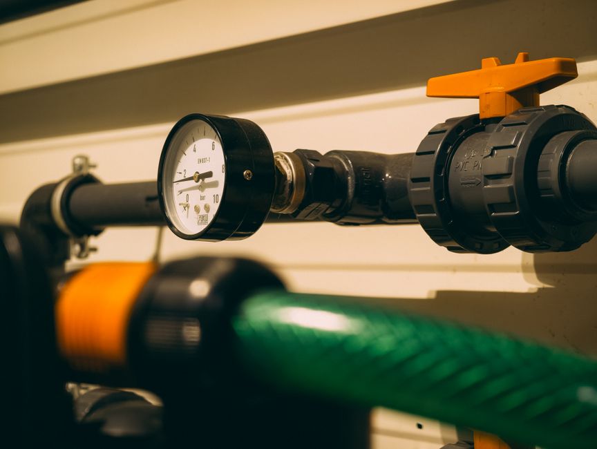 Pressure switch mounted on well system piping.