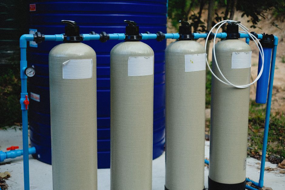 Residential water treatment and filtration setup in a basement utility area.